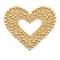 Heart shape formed by assorted gold-filled brass round spacer beads on a white background
