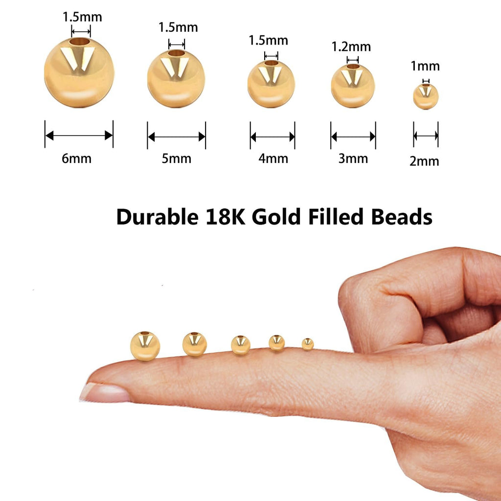 Various sizes of gold-filled round spacer beads shown on a fingertip and with dimension callouts.