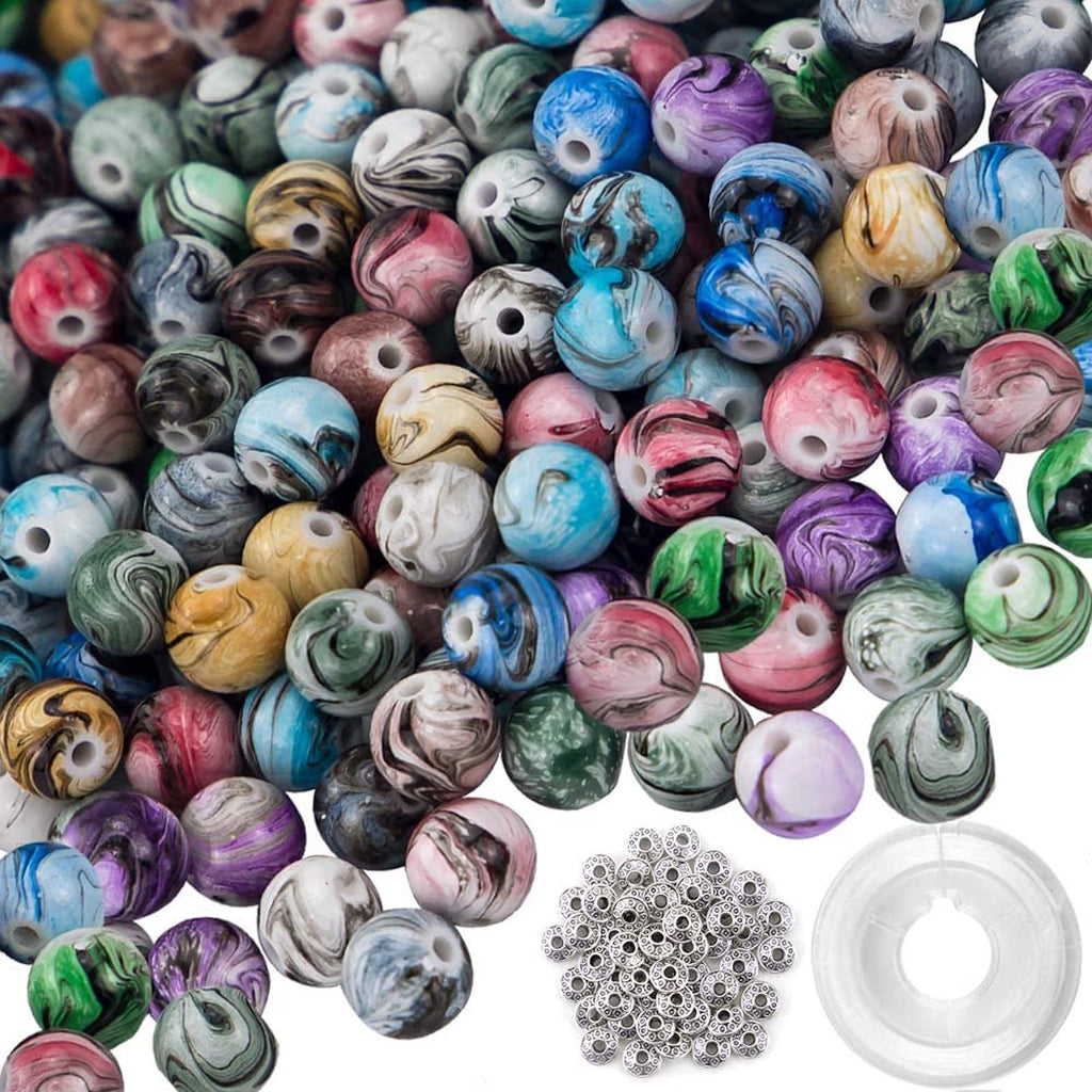 Pile of 8mm acrylic craft beads with ink patterns in various colors, plus spacer beads and crystal string.