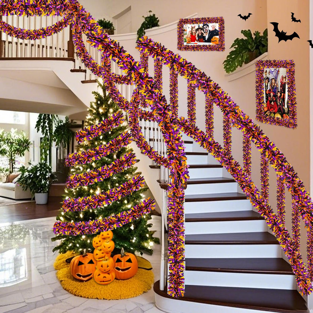 Orange, black, and purple tinsel garland draped on a staircase banister and around a Christmas tree with pumpkins.