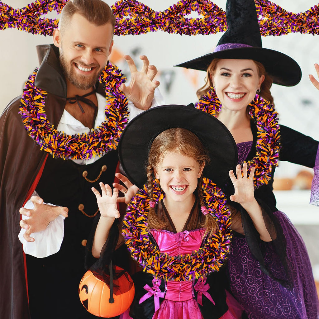 Family in Halloween costumes wearing orange, black, and purple tinsel garland.