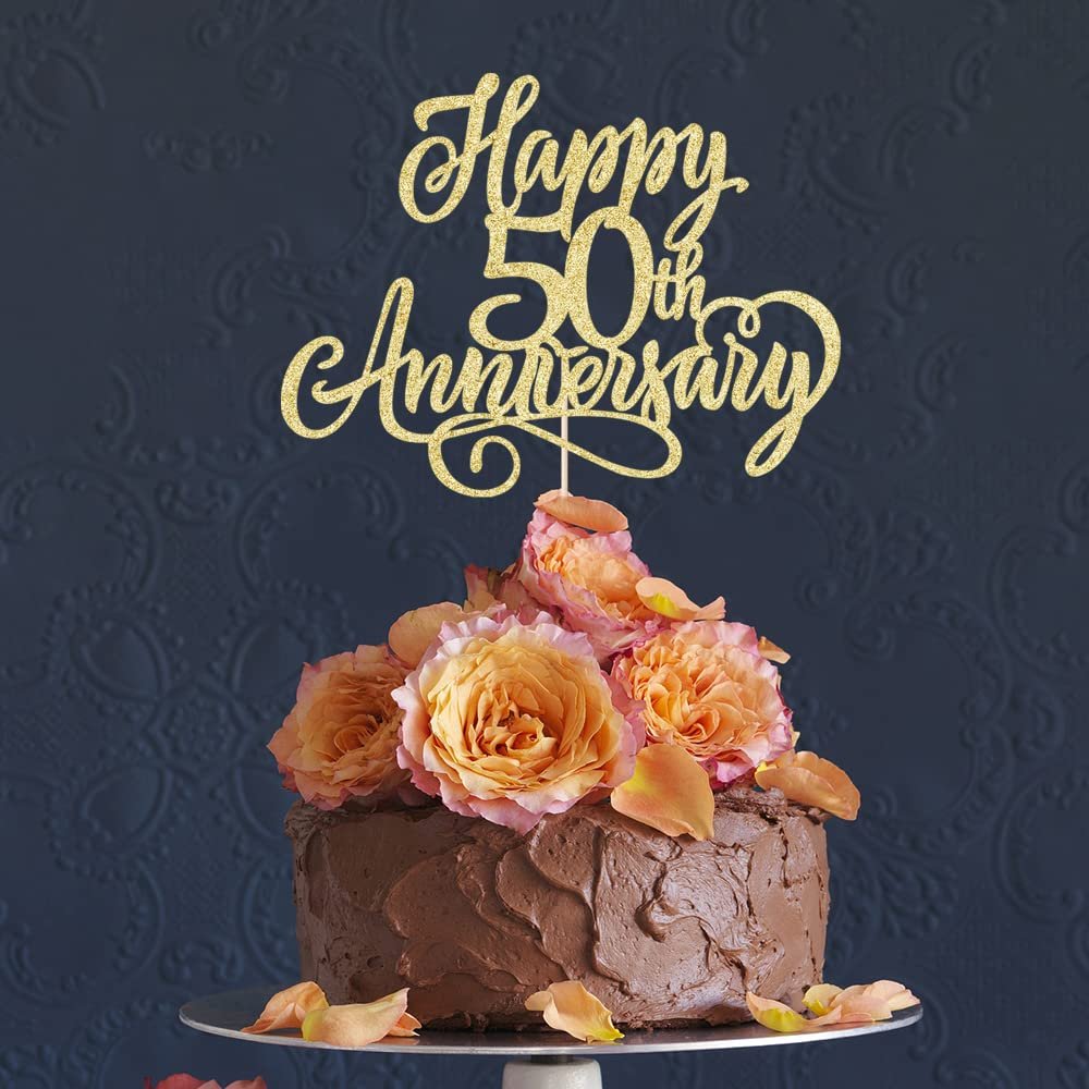 Golden glitter cake topper reading 'Happy 50th Anniversary' on a chocolate cake decorated with roses.