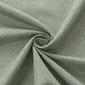 Sage green linen textured fabric tablecloth folded and swirled, showing texture and color.