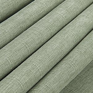 Sage green linen textured fabric tablecloth folded in soft waves