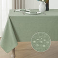 Sage green linen textured tablecloth draped over a table, with a close-up inset showing water droplets on the fabric.