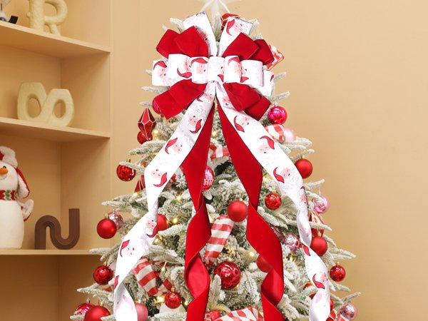 Christmas tree topper bow with Santa Claus pattern ribbon and red velvet ribbons, decorated on a flocked Christmas tree.