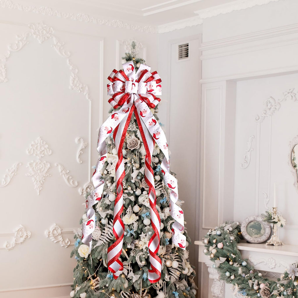 Large white and red Santa Claus patterned bow on top of a decorated Christmas tree