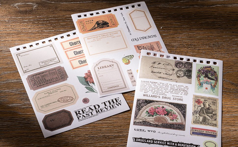 Vintage scrapbook stickers with various designs including tickets, labels, and postage stamps, arranged on paper sheets.