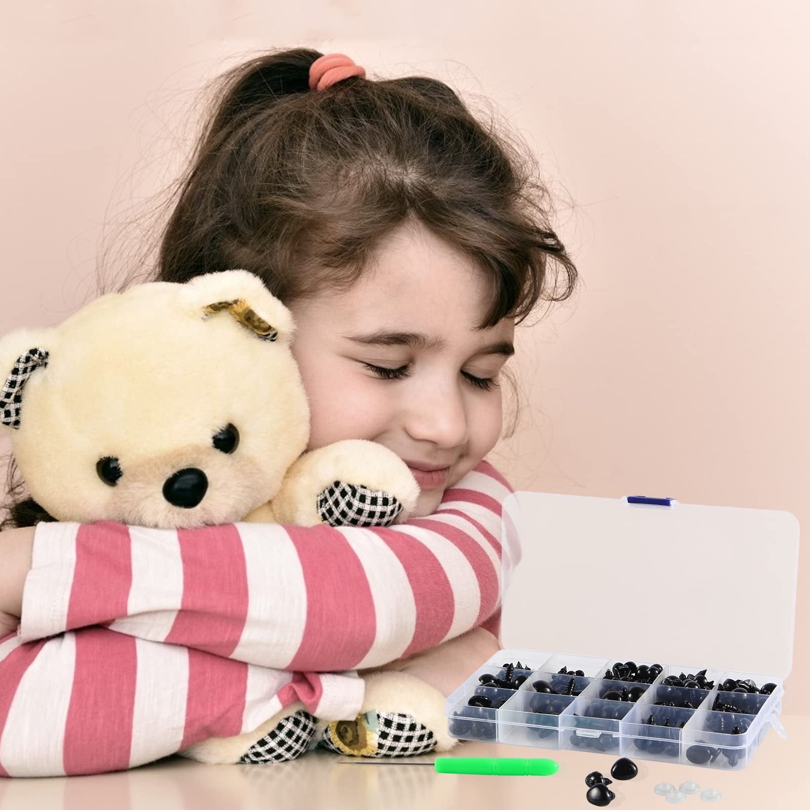 Young girl hugging a teddy bear with a storage box of assorted safety eyes and noses in the foreground