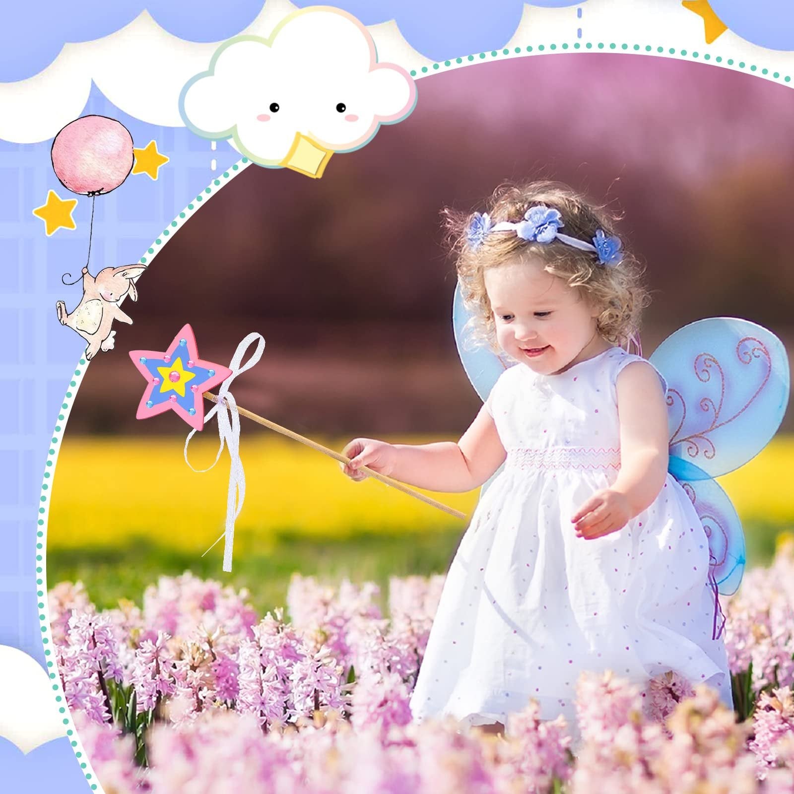 Toddler girl in a white dress and fairy wings holds a star wand in a field of pink flowers.