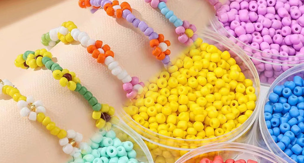 Close-up of colorful seed beads in clear containers and beaded flower bracelets