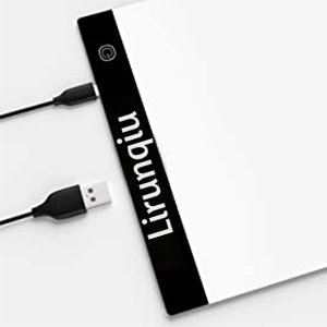 A4 size LED light pad for diamond painting, showing USB power cable plugged in, with brand name visible on the side.
