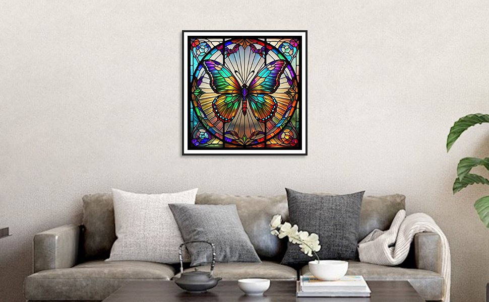 Framed stained glass butterfly artwork hanging above a sofa in a living room setting.