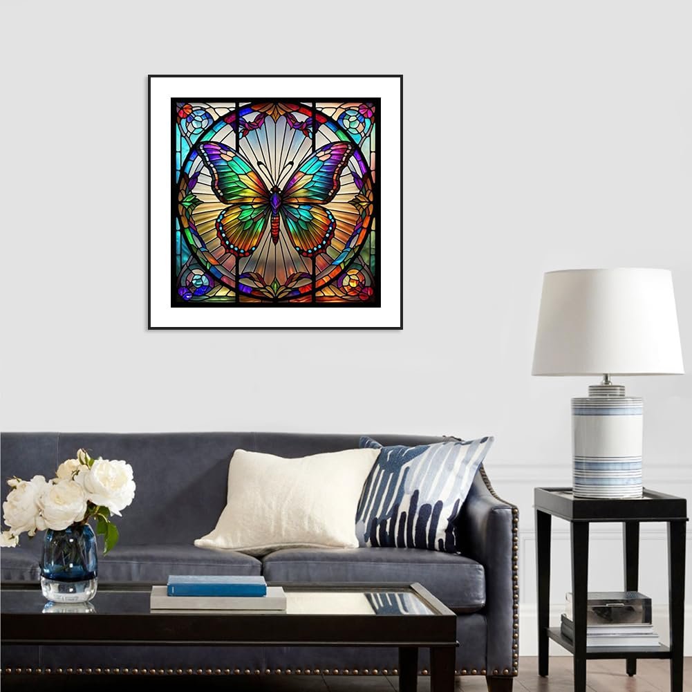 Framed stained glass butterfly art hanging above a sofa in a living room setting