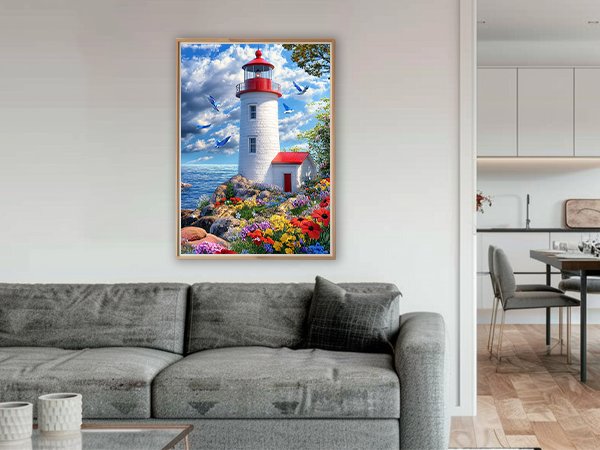 Diamond painting kit of a lighthouse on a rocky shore with colorful flowers and blue birds flying in a cloudy sky.