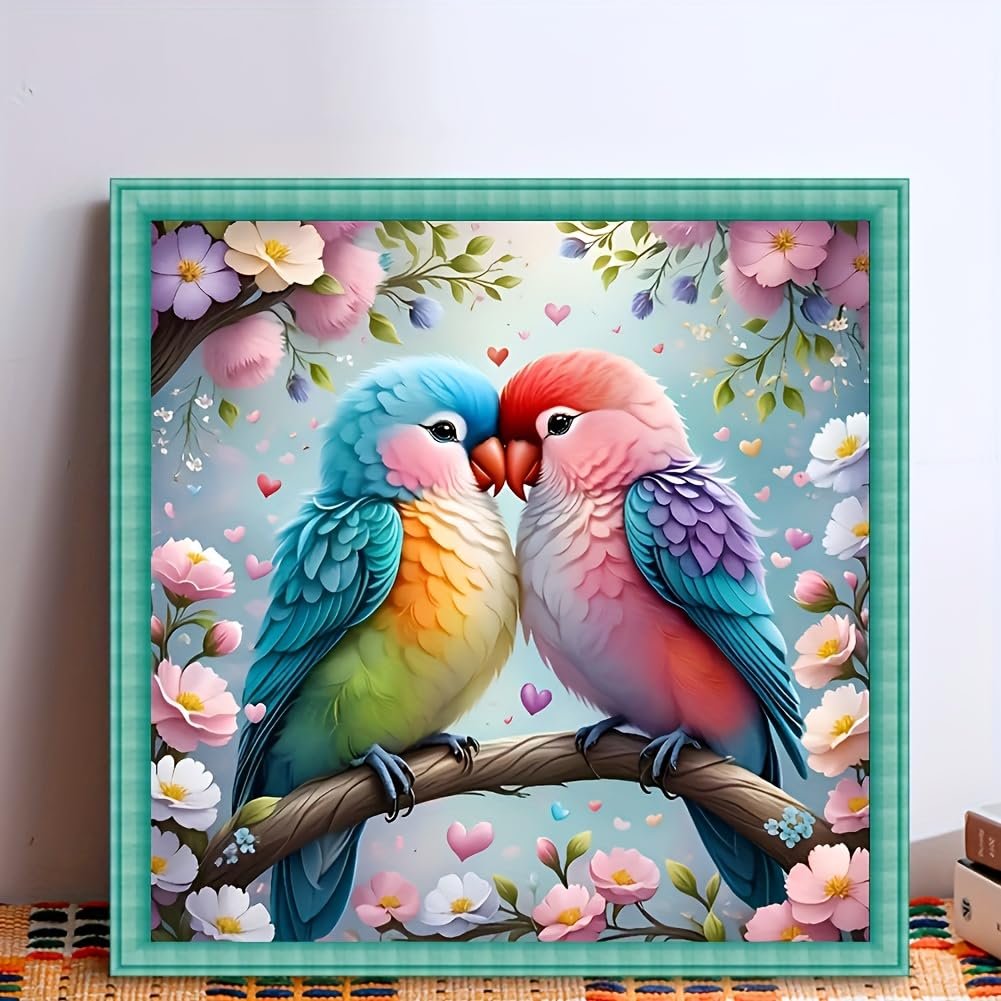 Two lovebirds perched on a branch surrounded by flowers and hearts, representing a diamond painting kit.