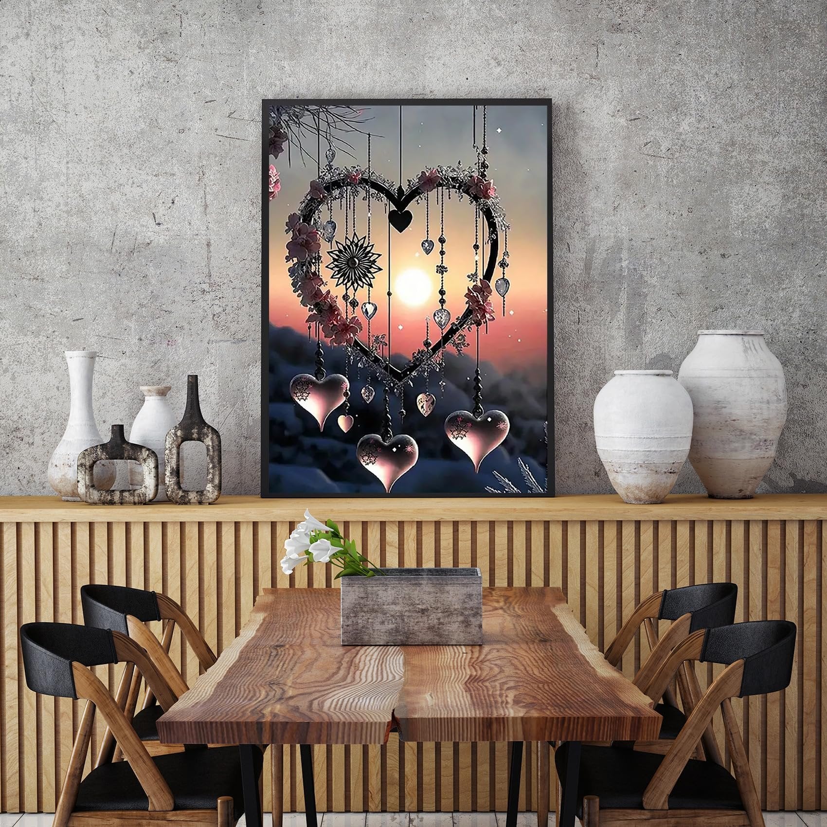 Framed diamond painting kit of a heart-shaped dream catcher with pink flowers and hanging hearts against a sunset sky.