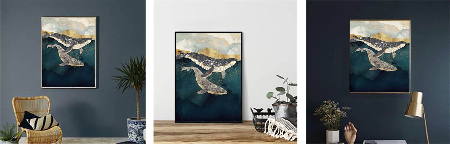 Abstract art print of two whales swimming in dark blue water with golden clouds above, framed and displayed in a room setting.
