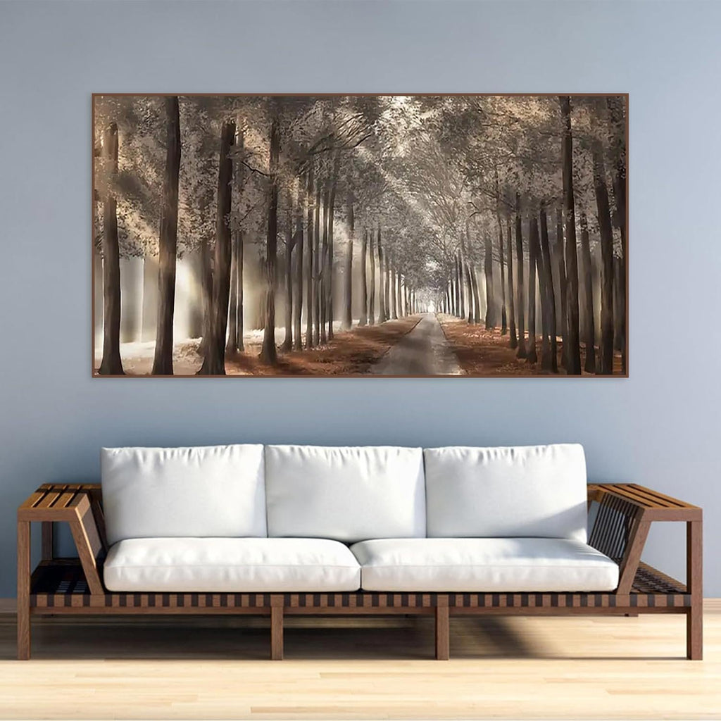 Diamond painting of a tree-lined path with sunlight filtering through the trees, displayed above a sofa.