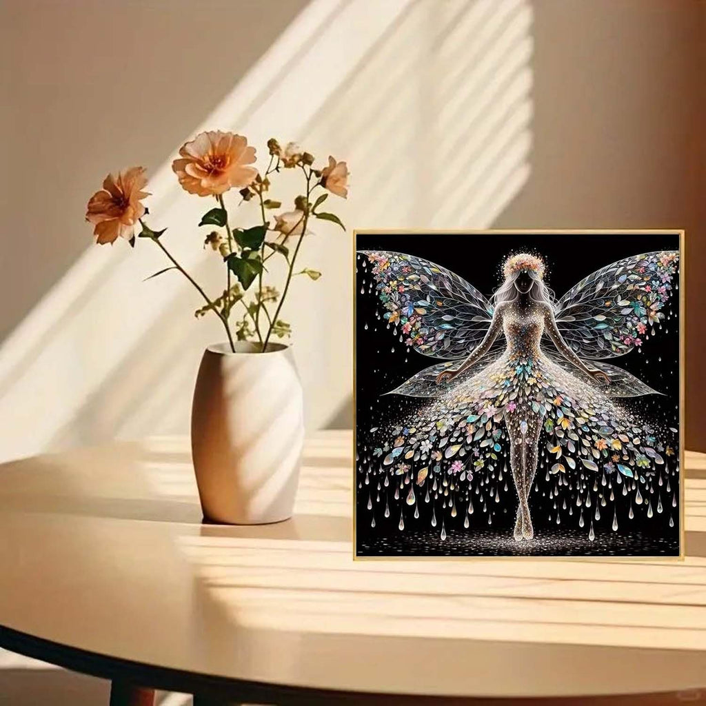 Diamond painting kit featuring a colourful angel wings fairy design on a black background, framed.