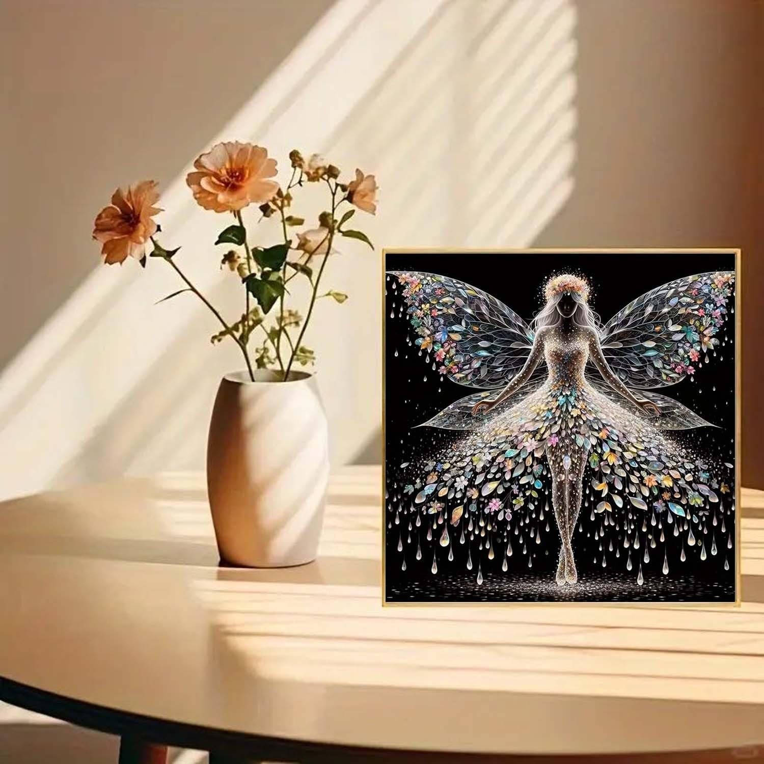 Diamond painting kit featuring a colourful angel wings fairy design on a black background, framed.