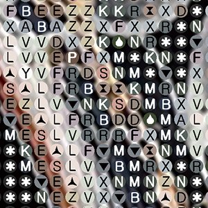 Close-up of diamond painting canvas with symbols and letters, abstract pattern.