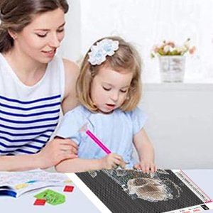 Woman and child doing a diamond painting kit with a high heel design on a table