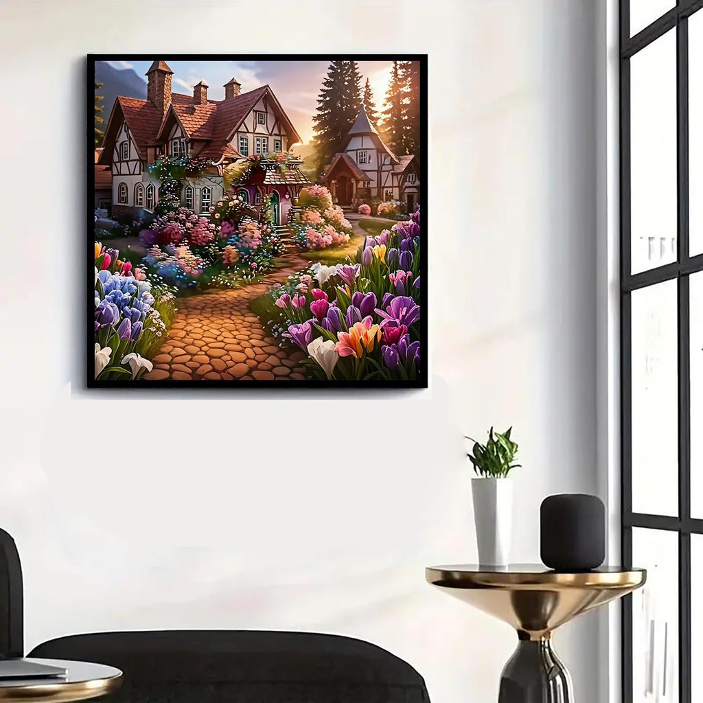 Diamond painting kit of a charming house with a flower-lined cobblestone path, set against a backdrop of trees and a sunset.