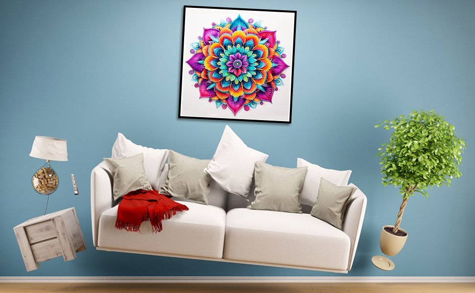 Framed colorful mandala artwork hanging above a floating white sofa with pillows and a red throw blanket.