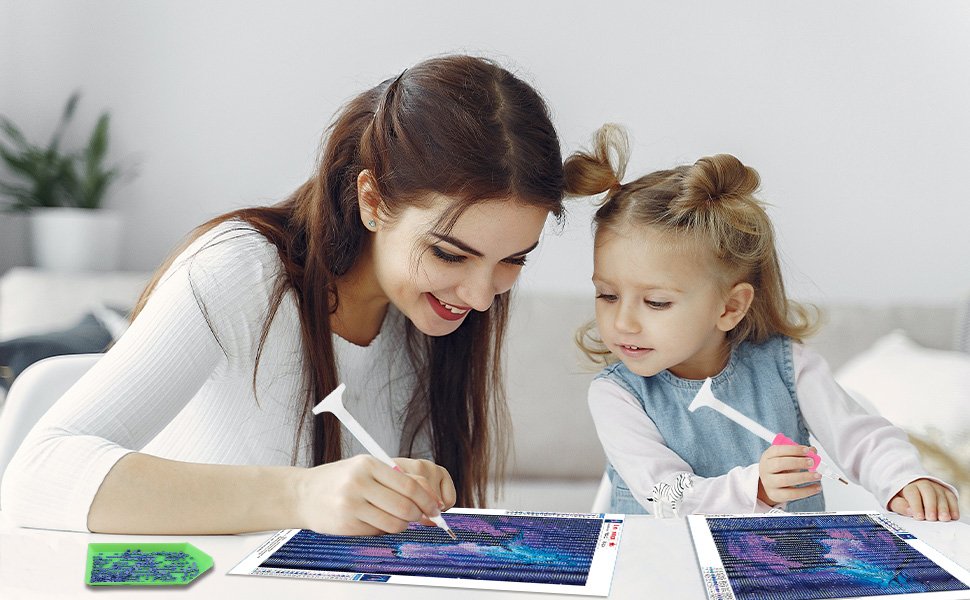 Woman and child doing diamond painting kit at a table, with tools and drills visible.
