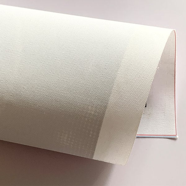 Rolled diamond painting canvas showing textured fabric and a glimpse of printed design on the underside.