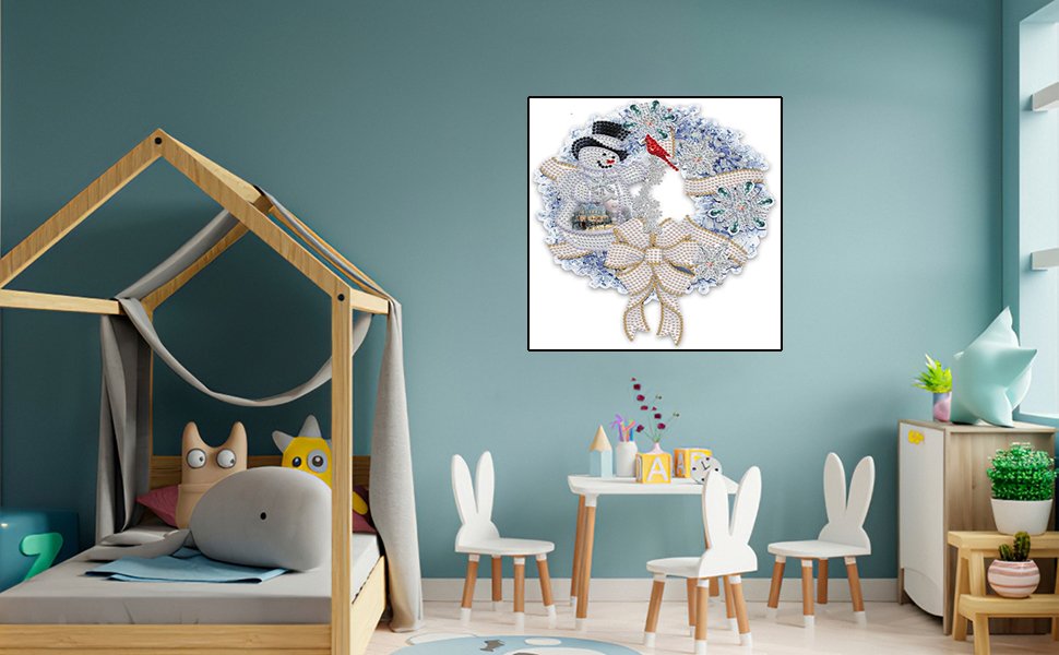 Diamond painting kit of a Christmas wreath with a snowman and bow, displayed in a child's room.