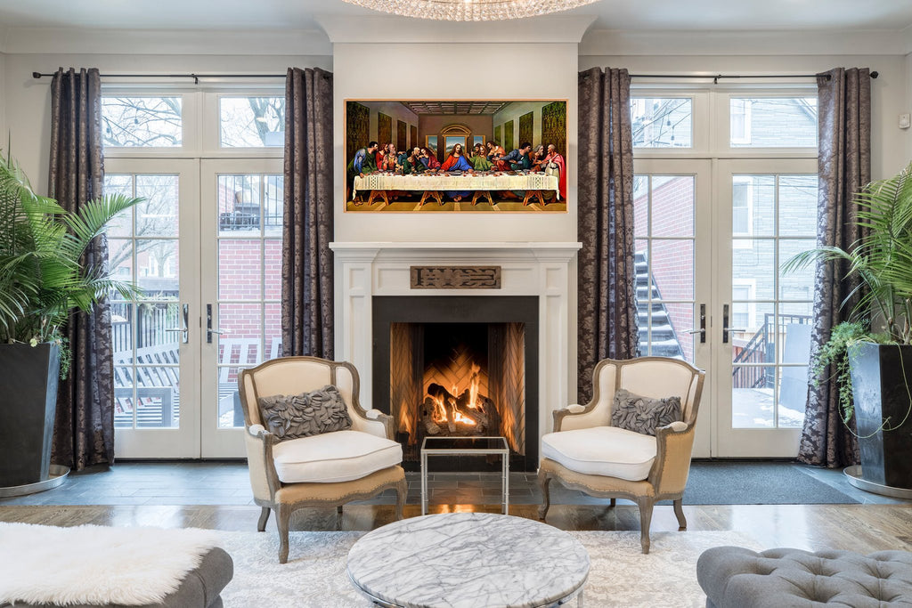 Living room with a framed painting of The Last Supper above a fireplace, flanked by chairs and plants.
