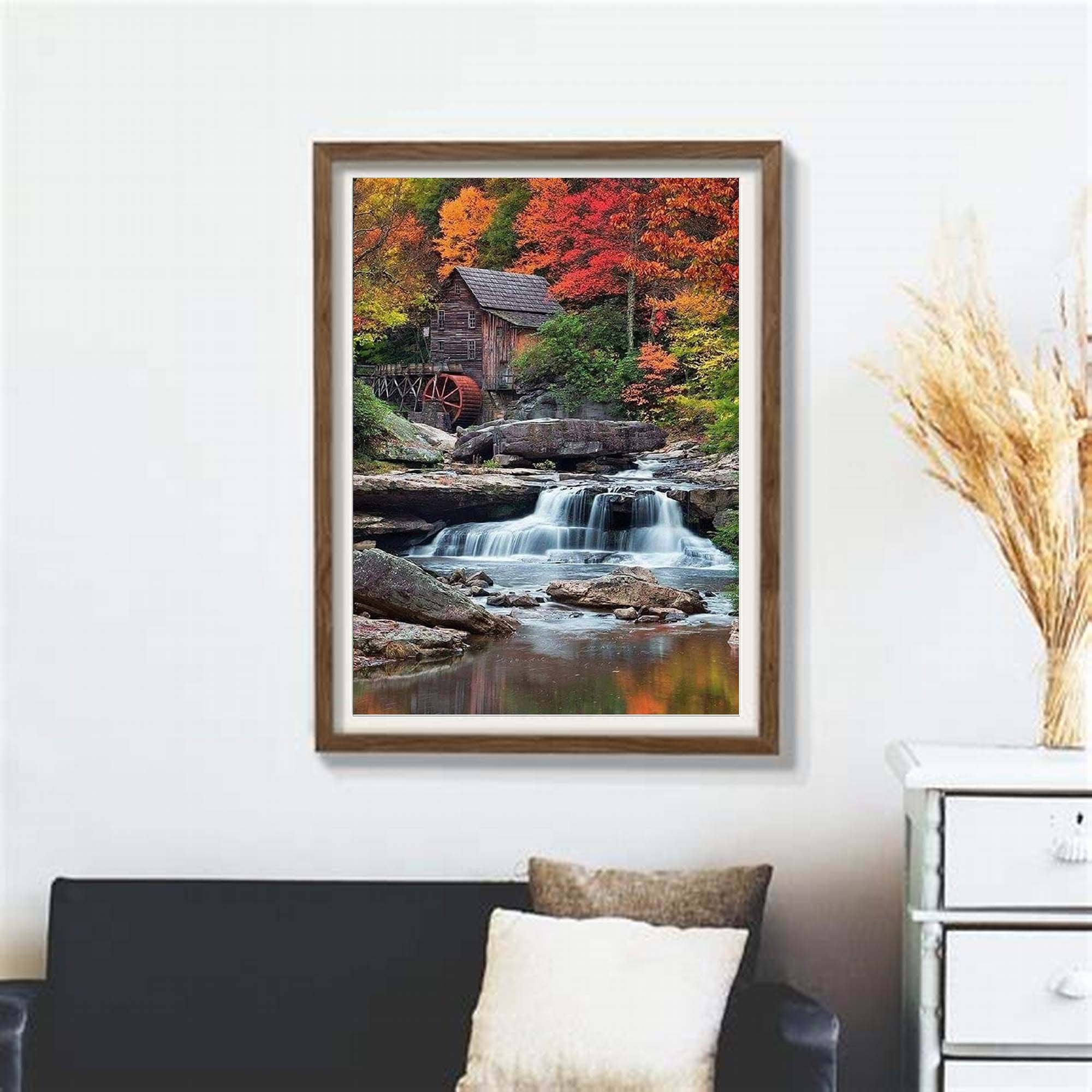 Framed diamond painting kit showing a rustic wooden mill beside a waterfall during autumn.