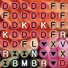 Close-up of numbered and lettered adhesive circles for diamond painting kit, showing a grid of symbols.