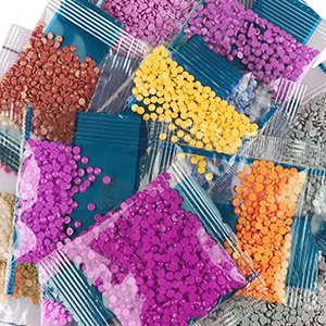 Diamond painting beads in small plastic bags, assorted colors, close-up view