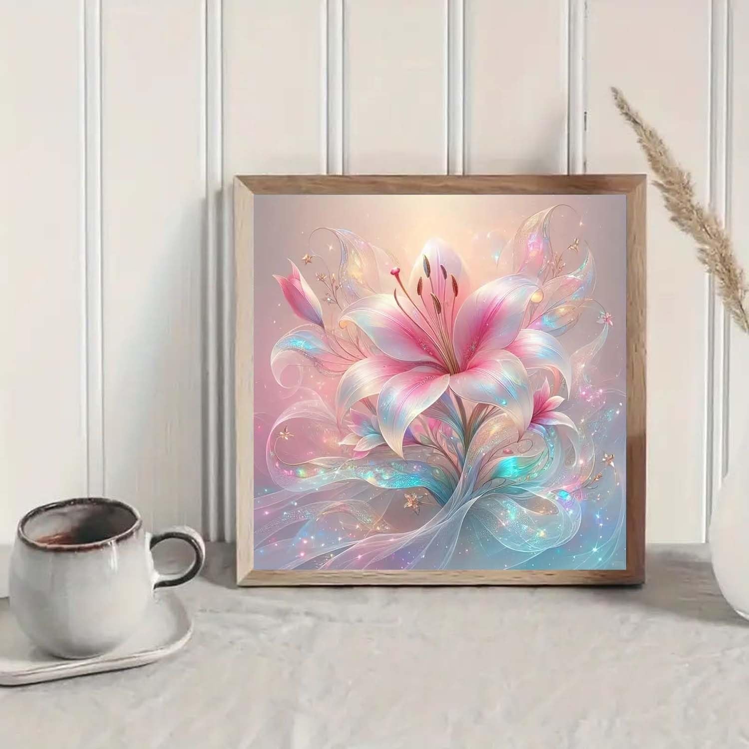 Framed diamond painting kit featuring a pink lily with iridescent, flowing ribbons and sparkles.