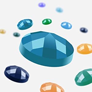 Close-up of a large blue faceted diamond painting gem surrounded by smaller colorful gems on a white background.