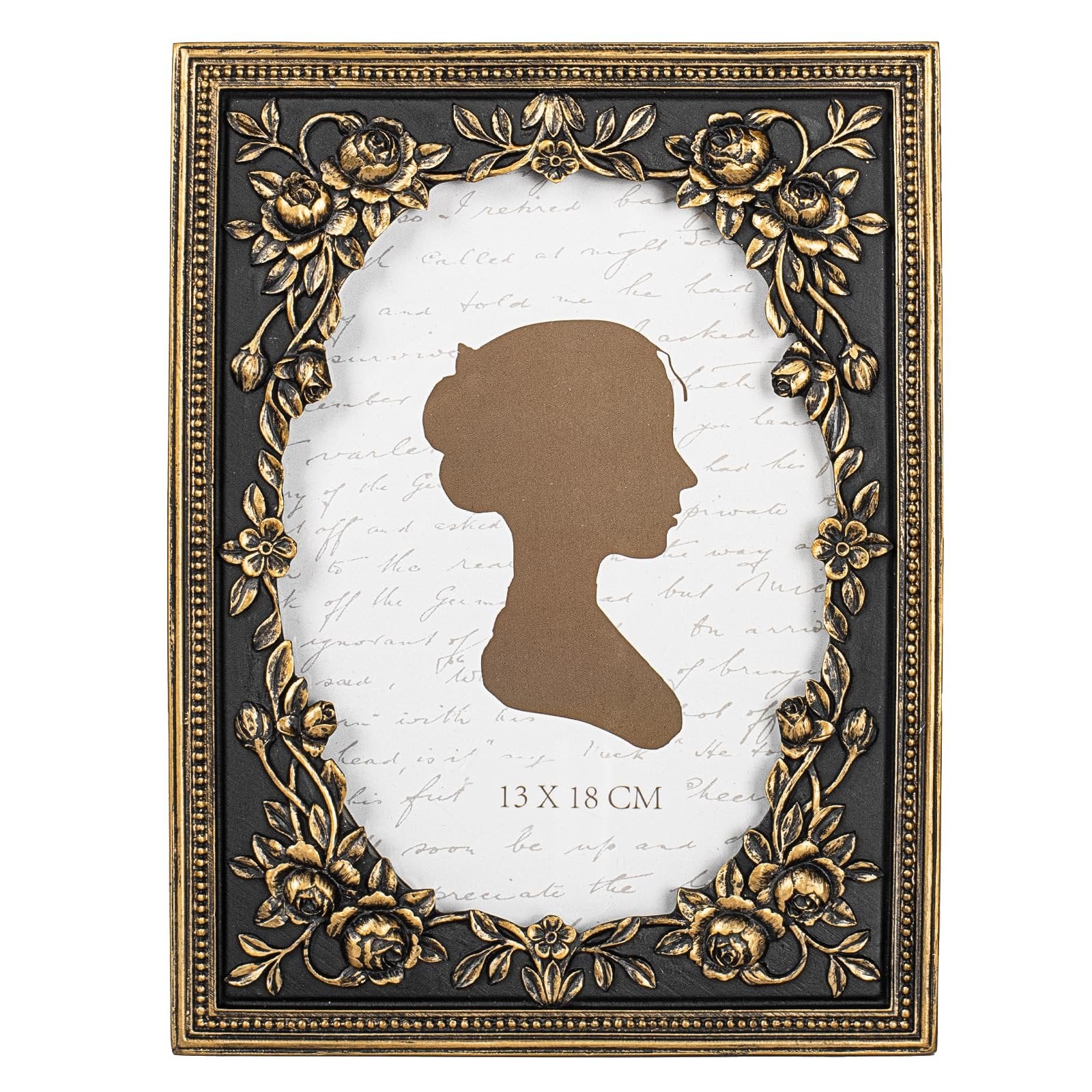 Vintage black and gold ornate picture frame with floral accents and a silhouette cutout, showing a handwritten script background.