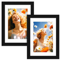 Two black picture frames displaying women in a field of flowers, one laughing, the other looking up