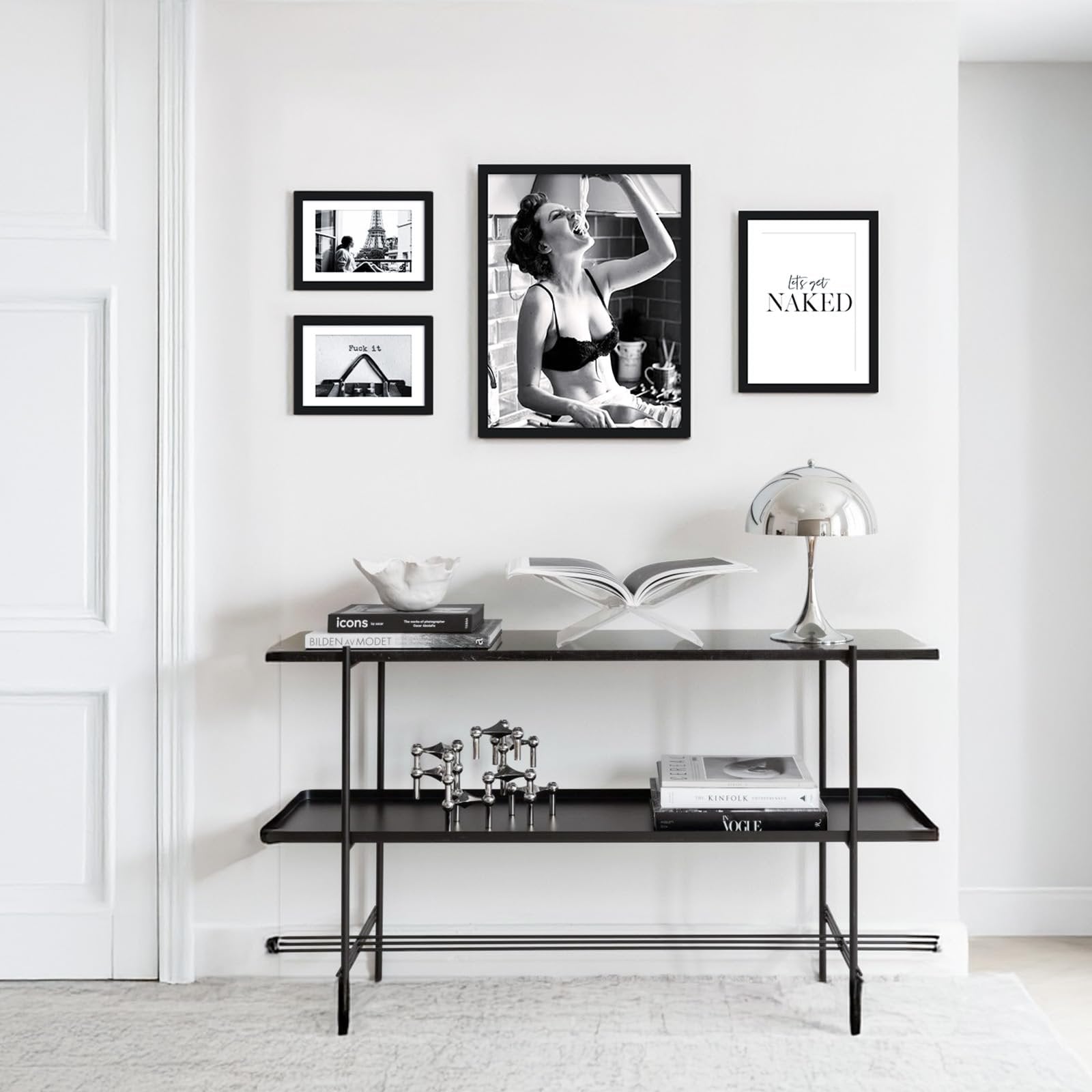Gallery wall with framed art and photos above a console table with books and decor
