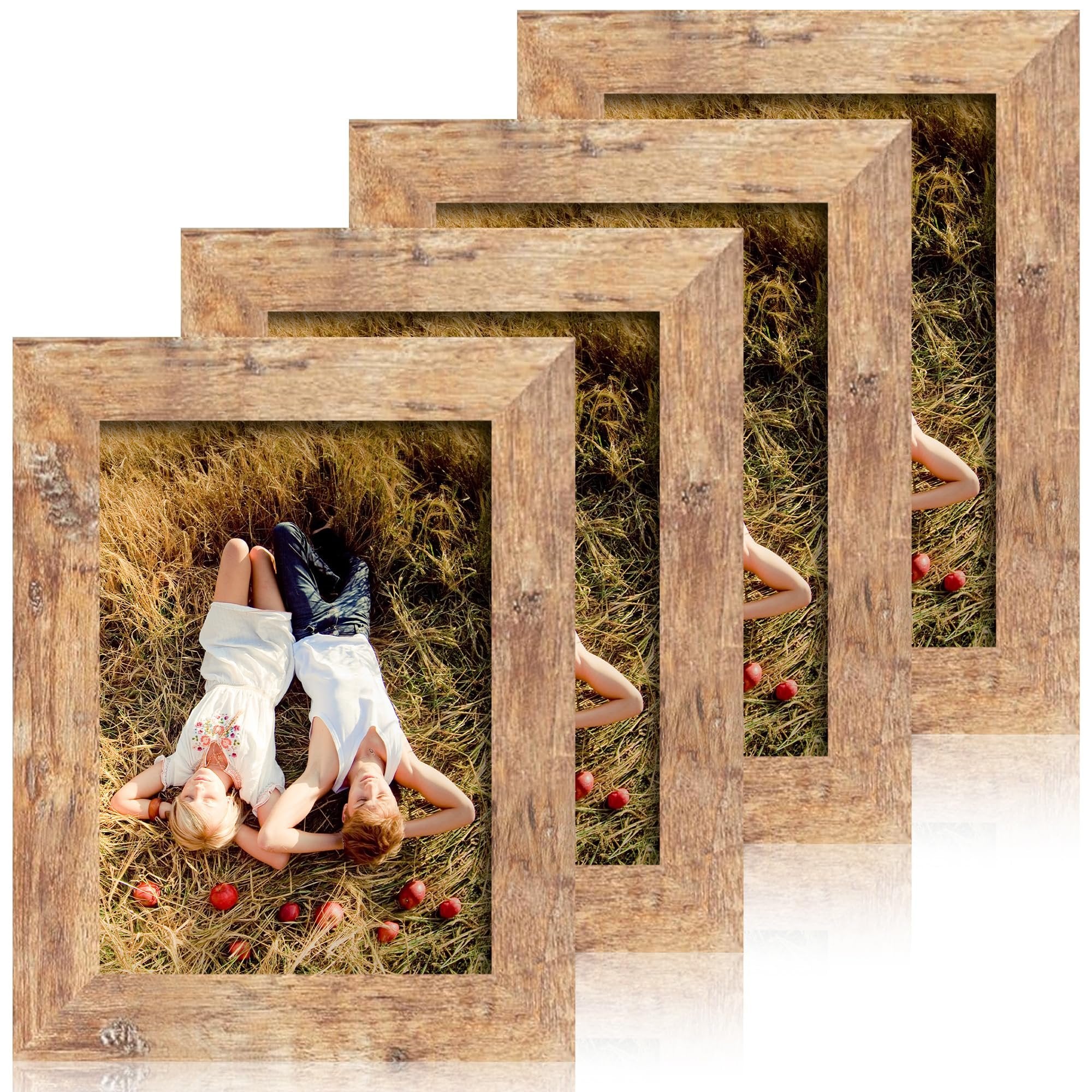 Set of four rustic brown picture frames with a couple lying in dry grass inside the front frame