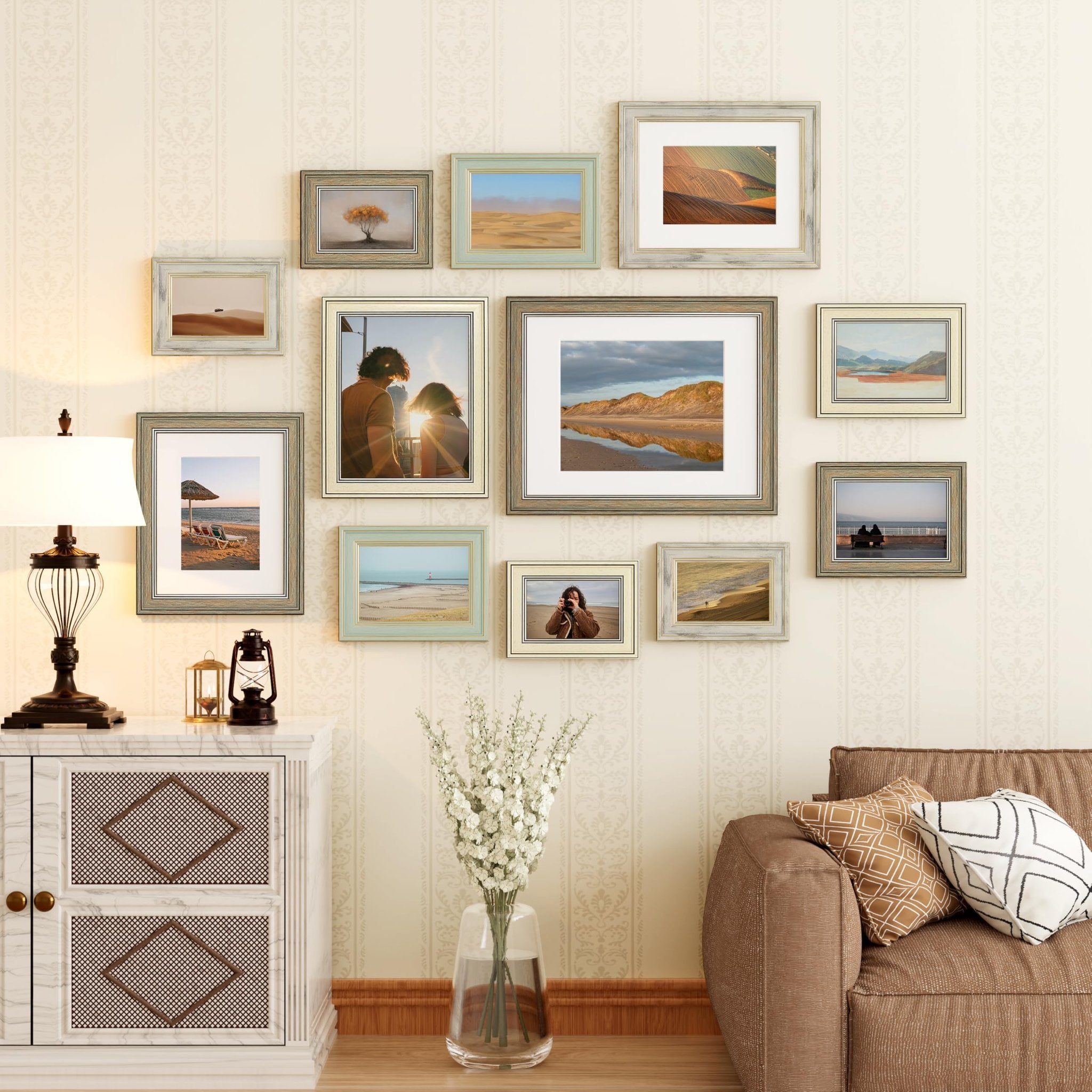 Gallery wall of vintage rustic farmhouse picture frames displaying landscape and couple photos above a sofa and cabinet.