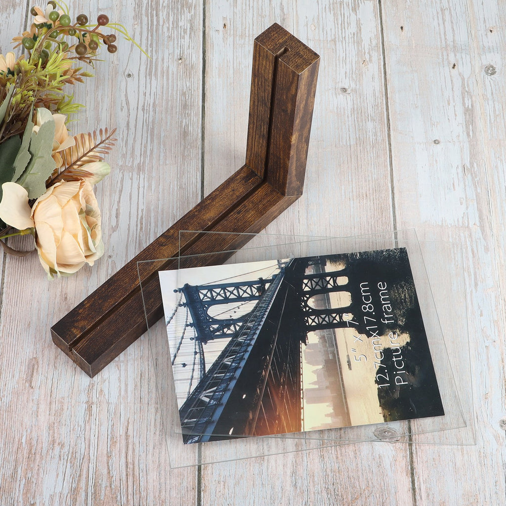 Wooden picture frame base with a 5x7 inch double-sided glass frame on a light wood background with floral accents.