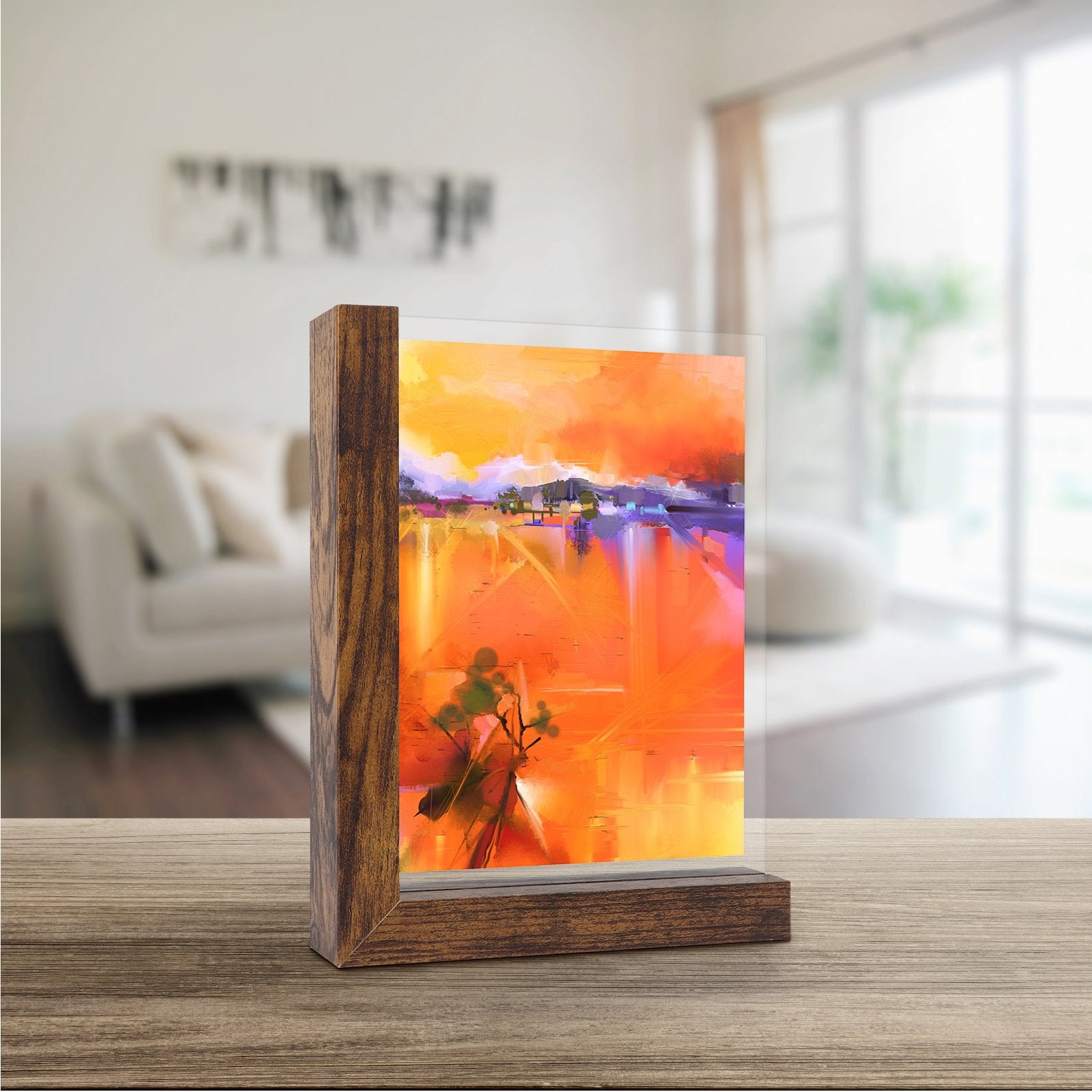 Wooden picture frame displaying abstract art on a table in a living room setting