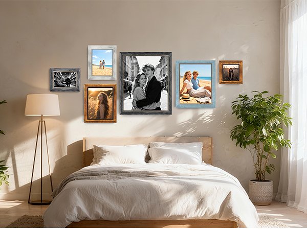 Gallery wall of rustic picture frames above a bed, featuring various photos and styles.
