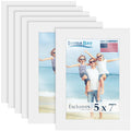 Six white 5x7 picture frames stacked, one showing a family on a beach.