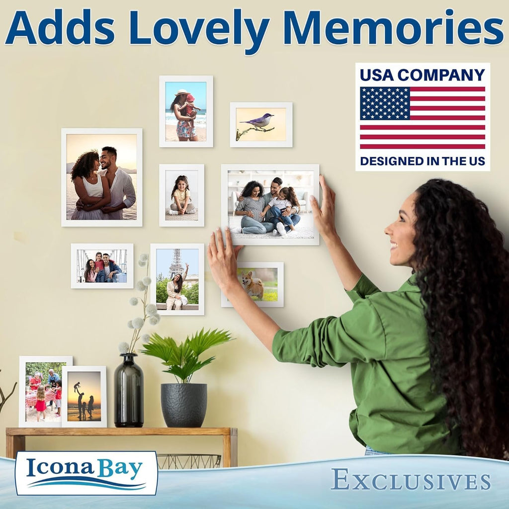 Woman arranging white picture frames on a wall, displaying family photos and a bird illustration.