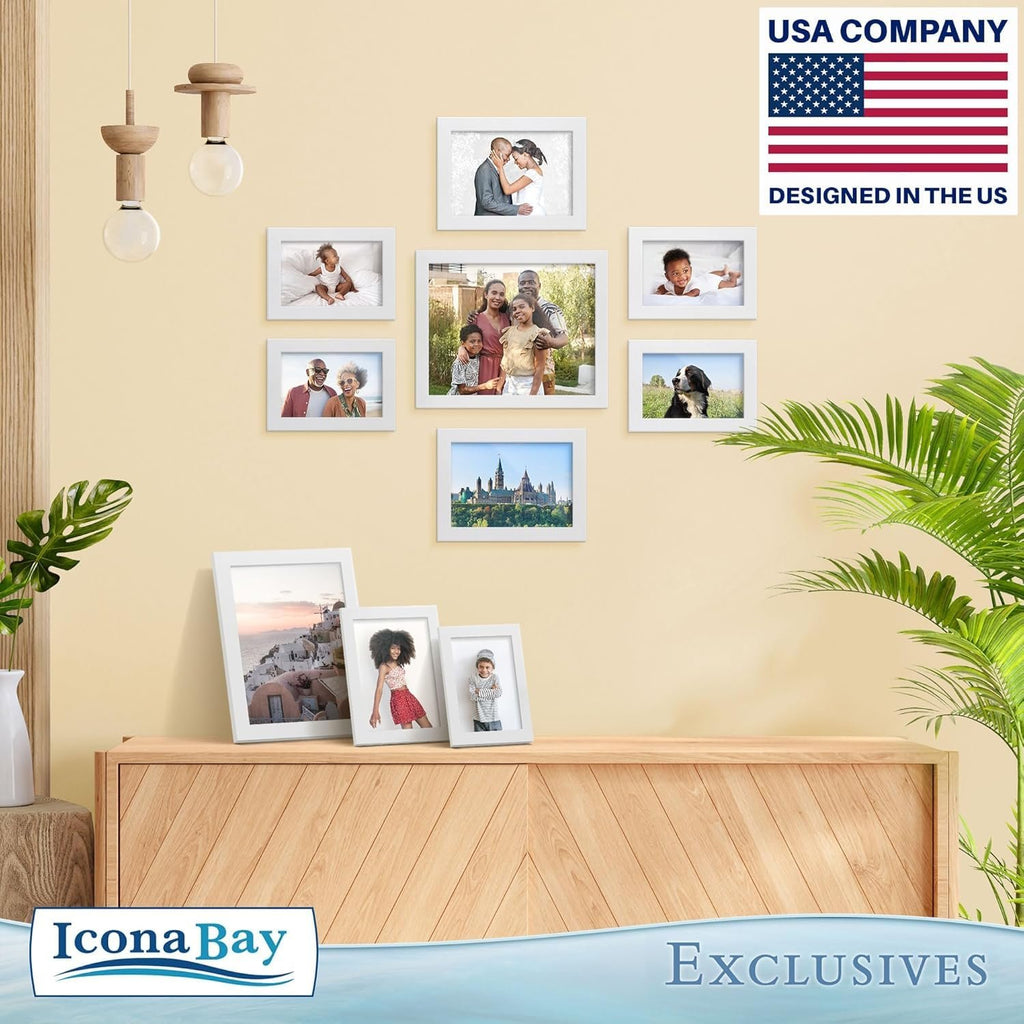 Gallery wall display of white picture frames with family photos and a dog on a light yellow wall above a wooden cabinet.
