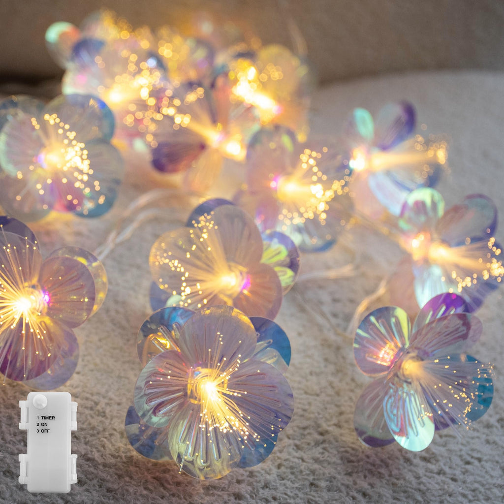 Fiber optic flower string lights with timer box, warm white glow on textured surface